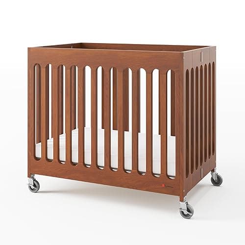 Foundations Boutique Compact Folding Crib, Modern, Contemporary, Mini Crib for Guest Rooms, Vacation Homes, and Small Nurseries, Available in 5 Finishes, Mattress Included (Cherry)