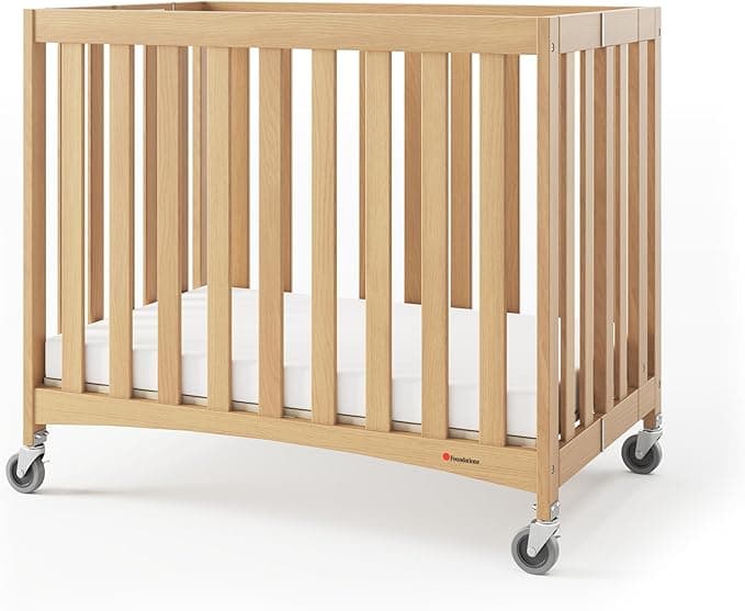 Foundations Travel Sleeper Compact Wooden Folding Crib, Portable Baby Crib with 2” InfaPure Foam Crib Mattress and Commercial Grade Casters, Hotel Crib (Natural)