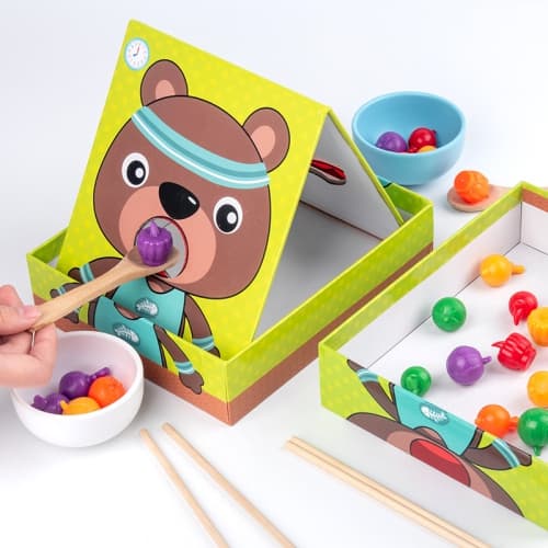 Feeding game with a sporty bear - a hands-on educational toy for early childhood education.